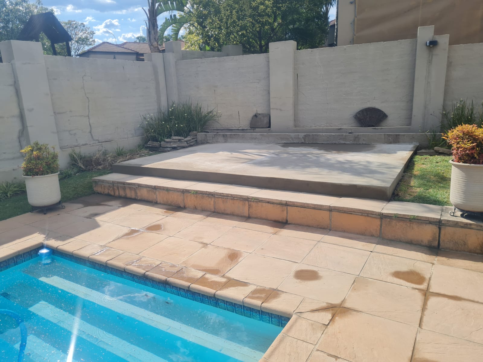 Backyard with concrete patio, pool, and outdoor renovation